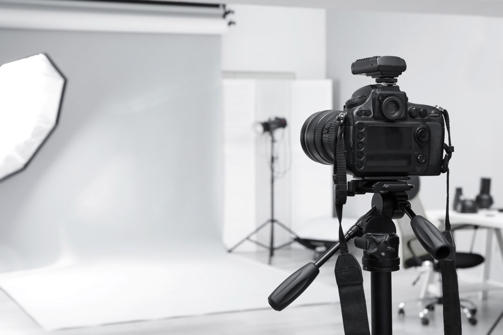 Photography studio with lighting and camera equipment set up for a photoshoot.