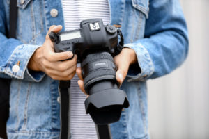 Camera being held in photographer's hands.