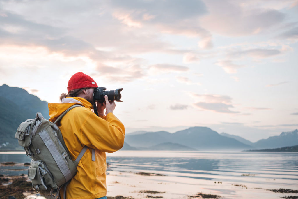 travel photographer taking pictures of nordic mountain scape