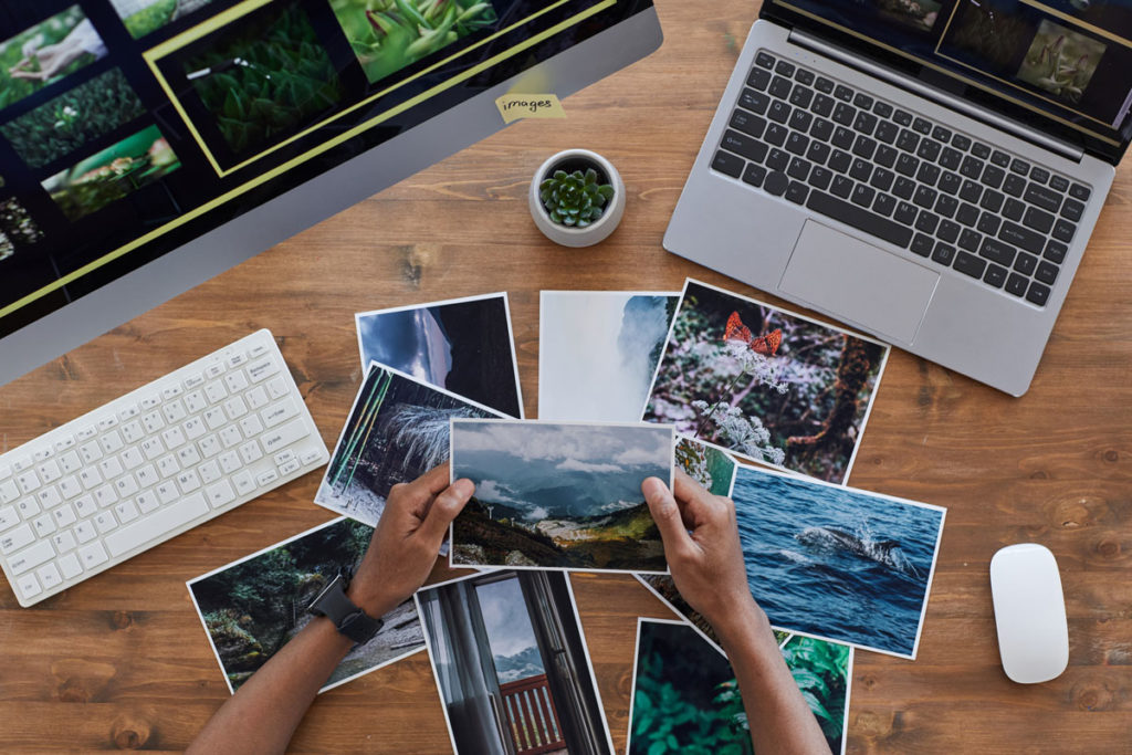 nature photos in pile on desk