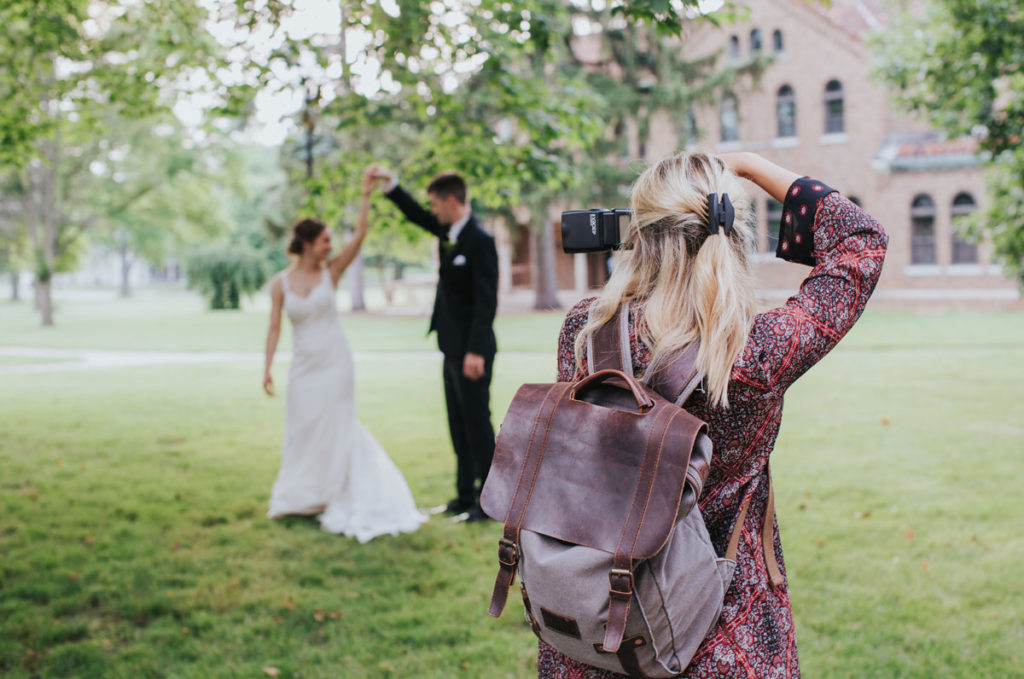 Wedding photographer taking photos of bride and groom