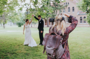 Wedding photographer taking photos of bride and groom