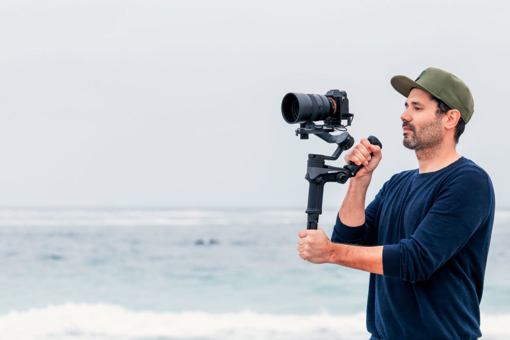 videographer holding camera on gimbal