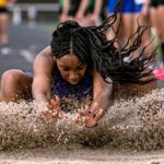 Woman landing after doing the long jump