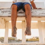 kids sandy toes sitting on lifeguard tower on the beach