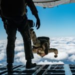 soldiers jumping out from the back of a plane