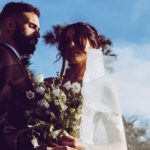 bride and groom holding each other and bouqet