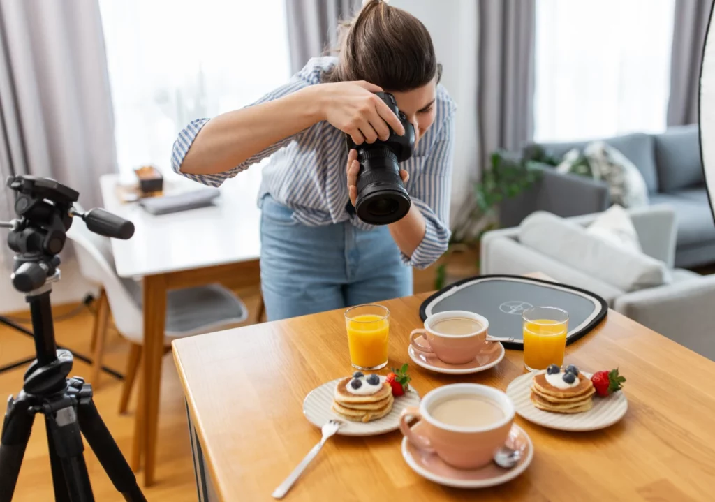 A food photographer photographing breakfast foods in her home.