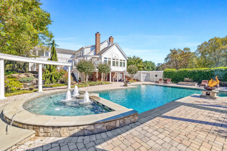 An exterior shot of a backyard pool.