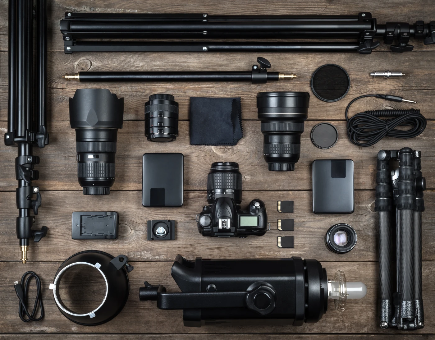 Different photographer tools laid out neatly on a table.
