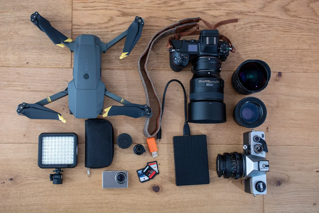 Top view of photography and drone photography equipment on a wood table.