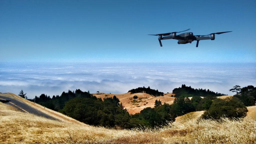 Drone flying over a wooded area