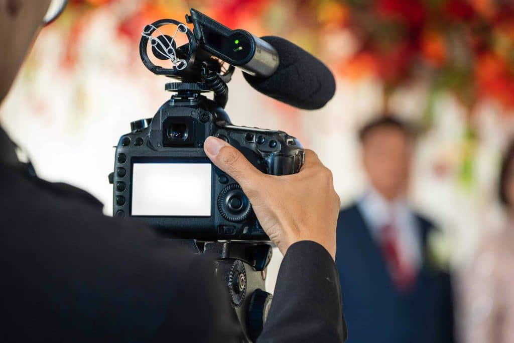 photographer taking pictures of bride and groom