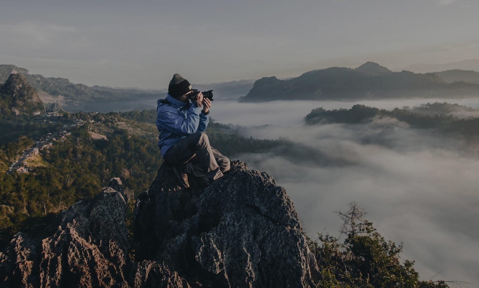 photographer taking a photo on a large mountain