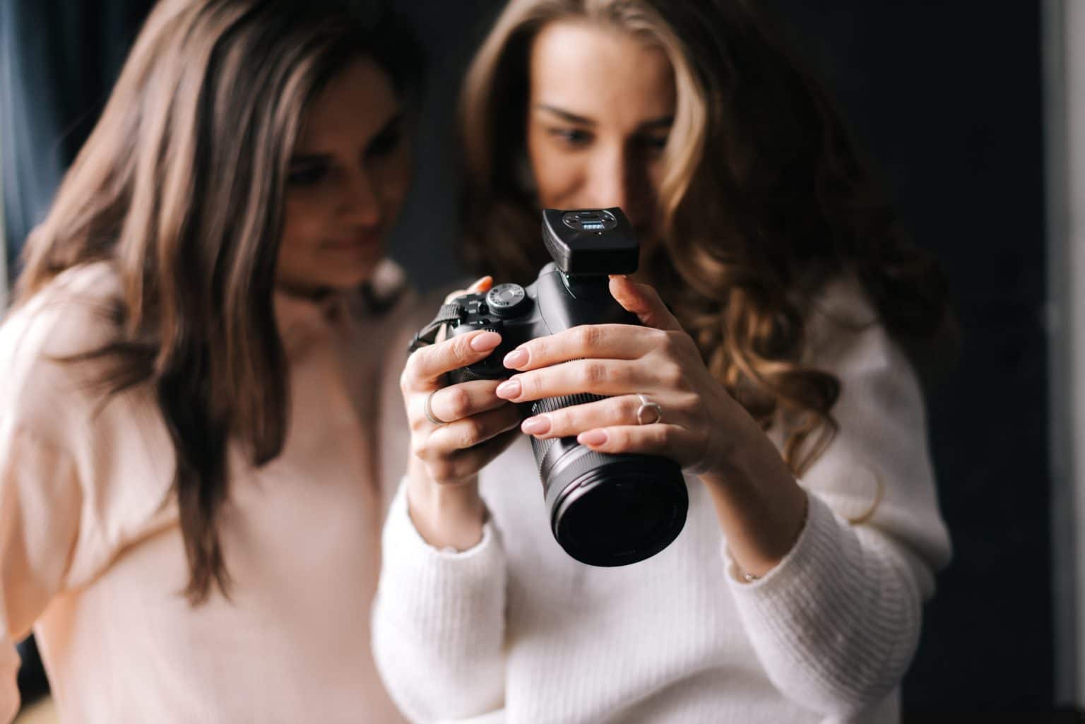 Two women showing photos on a camera