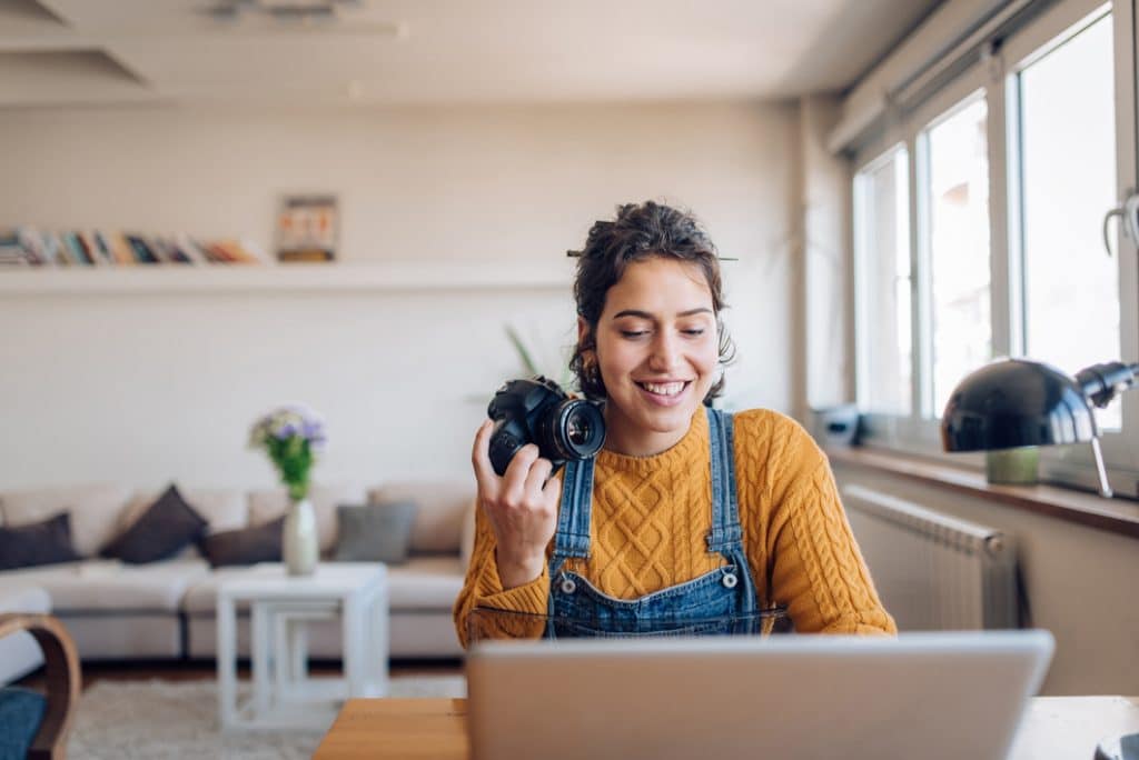 Young photographer working on her photos at her home office