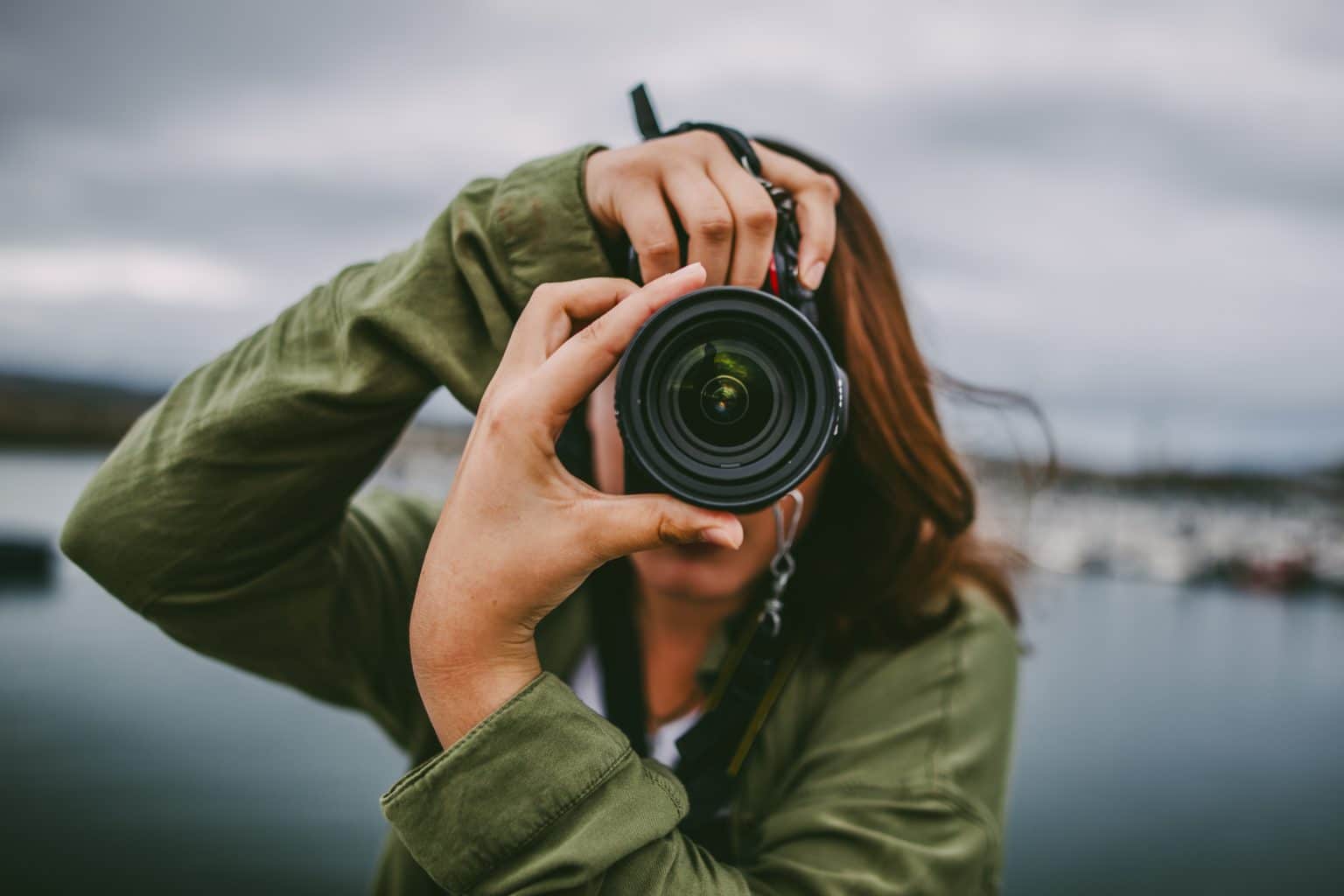 Young woman using DSLR camera