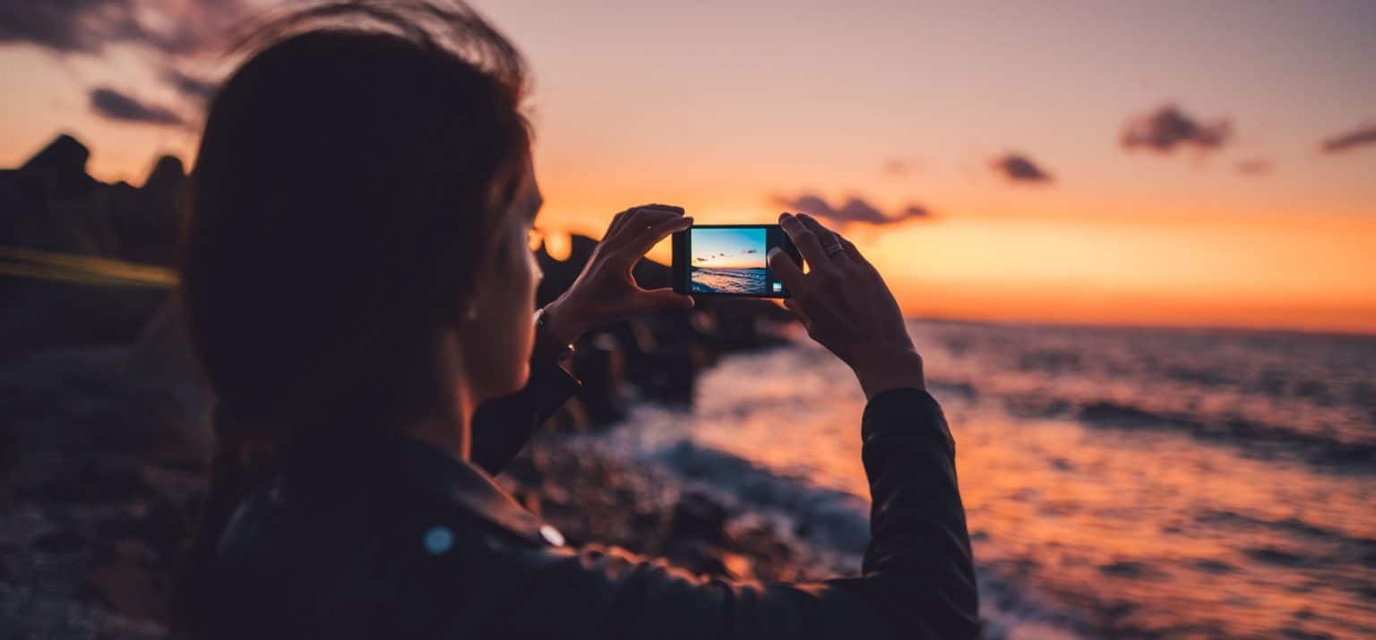 photographer taking photos at night on the beach