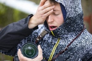 Stressed Young Adult Photographer Holding Camera With Broken Glass on Lens