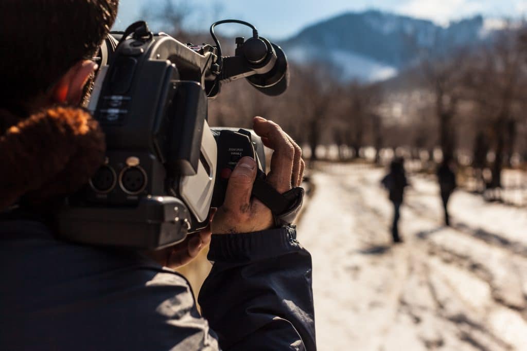 man using a professional video recorder outdoor